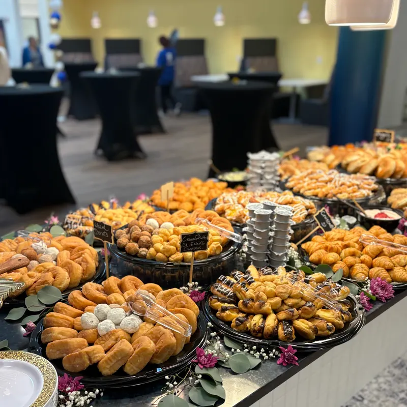 Corporate brunch spread of pastries, donuts, croissants, and eclairs at a Central Florida event space